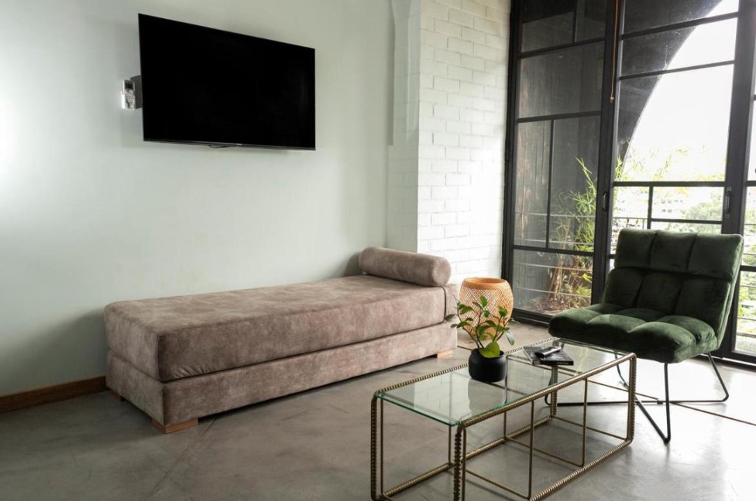 Spacious and well-lit living room in Hotel Medellin Nido Sky with designer furniture